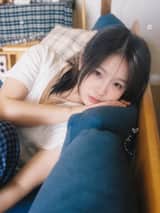 一位二十多岁的年轻东亚女性，黑色长发随意扎成低马尾