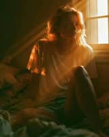Photorealistic bedroom scene in warm late-afternoon sunlight