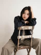 Create a restrained studio fashion portrait with an exact