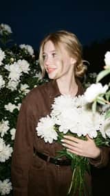 A candid nighttime editorial portrait of a young blonde