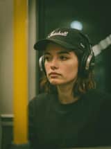 Photorealistic cinematic portrait of a young woman sitting