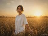 Warm golden hour film portrait, young woman walking slowly