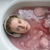 Ultra-Photorealistic Cinematic Portrait in a Bathtub with Noise-Canceling Headphones