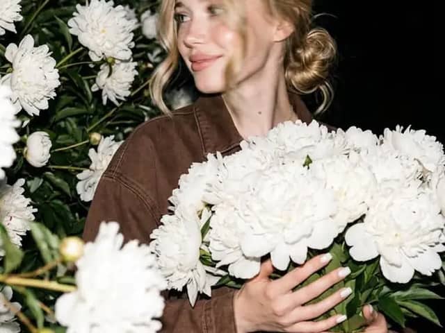 A candid nighttime editorial portrait of a young blonde