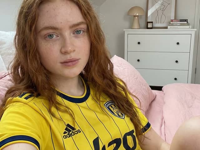 Photorealistic Selfie of Sadie Sink in a Soccer Jersey