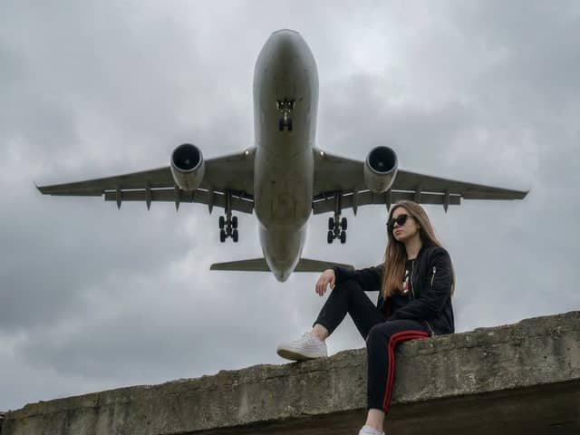 Surreal Low-Angle Portrait with Low-Flying Airplane Prompt