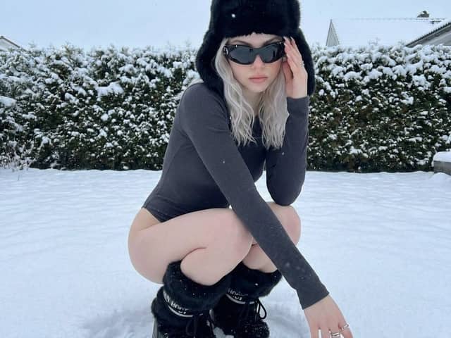 Winter Editorial Low-Angle Squat Pose Prompt (iPhone Style)