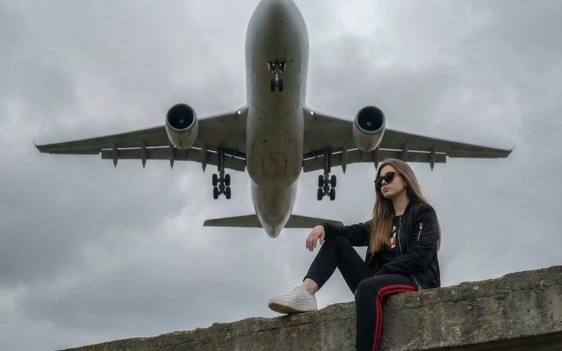 Surreal Low-Angle Portrait with Low-Flying Airplane Prompt