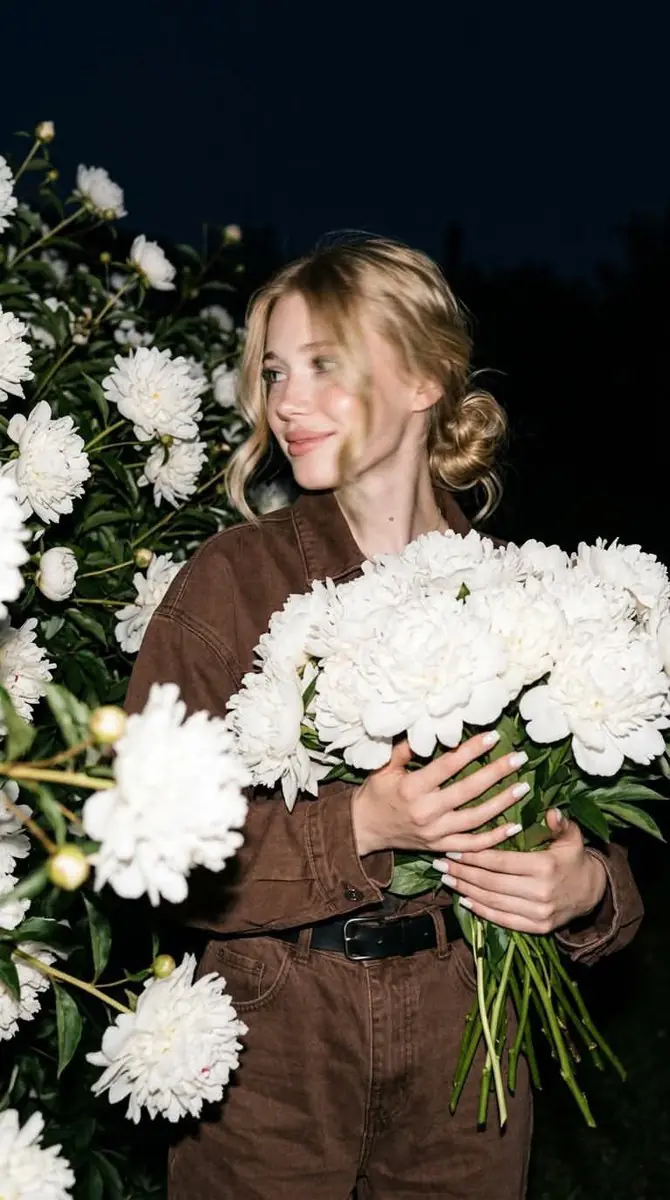 A candid nighttime editorial portrait of a young blonde